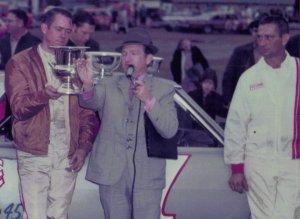 "The car and I were able to establish a rapport today," Burcham said after this win at Middle Georgia Racway in 1968. Burcham recieves the trophies from announcer Jimmy Mosteller. To the right is Bob's right arm mechanic, Hoss Jackson.