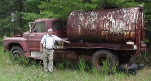 Irvin poses with the old water truck from the Banks County Speedway. Photo courtesy Eddie Samples