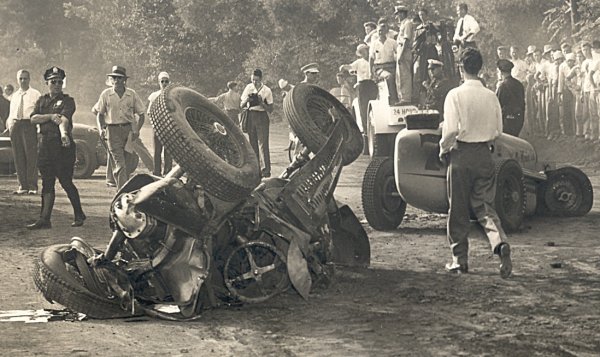 Both Robson's car (pictured left) and Barringer's (pictured right) came to rest just before the culvert on the backstretch.  Note the condition of the right-rear tire on Robson's overturned car, suggesting wheel-to-wheel contact.  Photo courtesy Eddie Samples