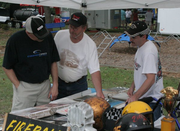 Harold Pritchett, pictured center, points out an item of interest to his brother, C.L., pictured left and Neil Rucker, pictured right.